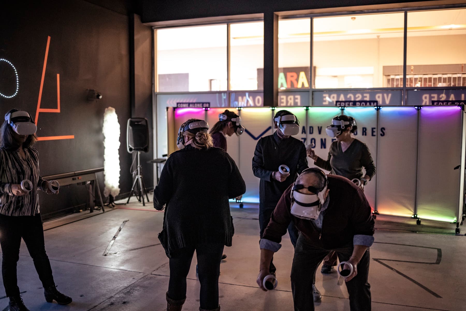 Coworkers in headsets walking and chatting between games at a company event