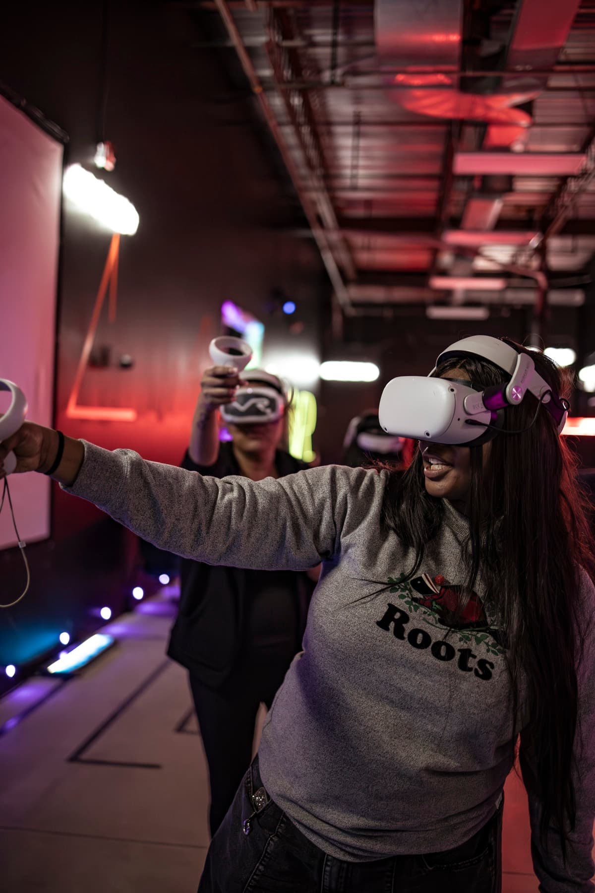 A guest laughing while pointing a VR controller mid-game