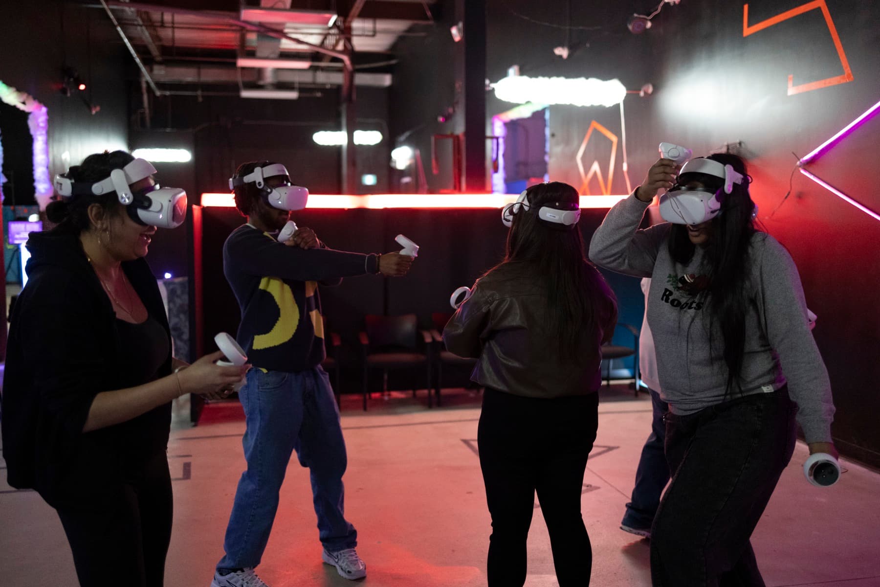 Coworkers laughing and playing a VR game together at a company party in Ottawa