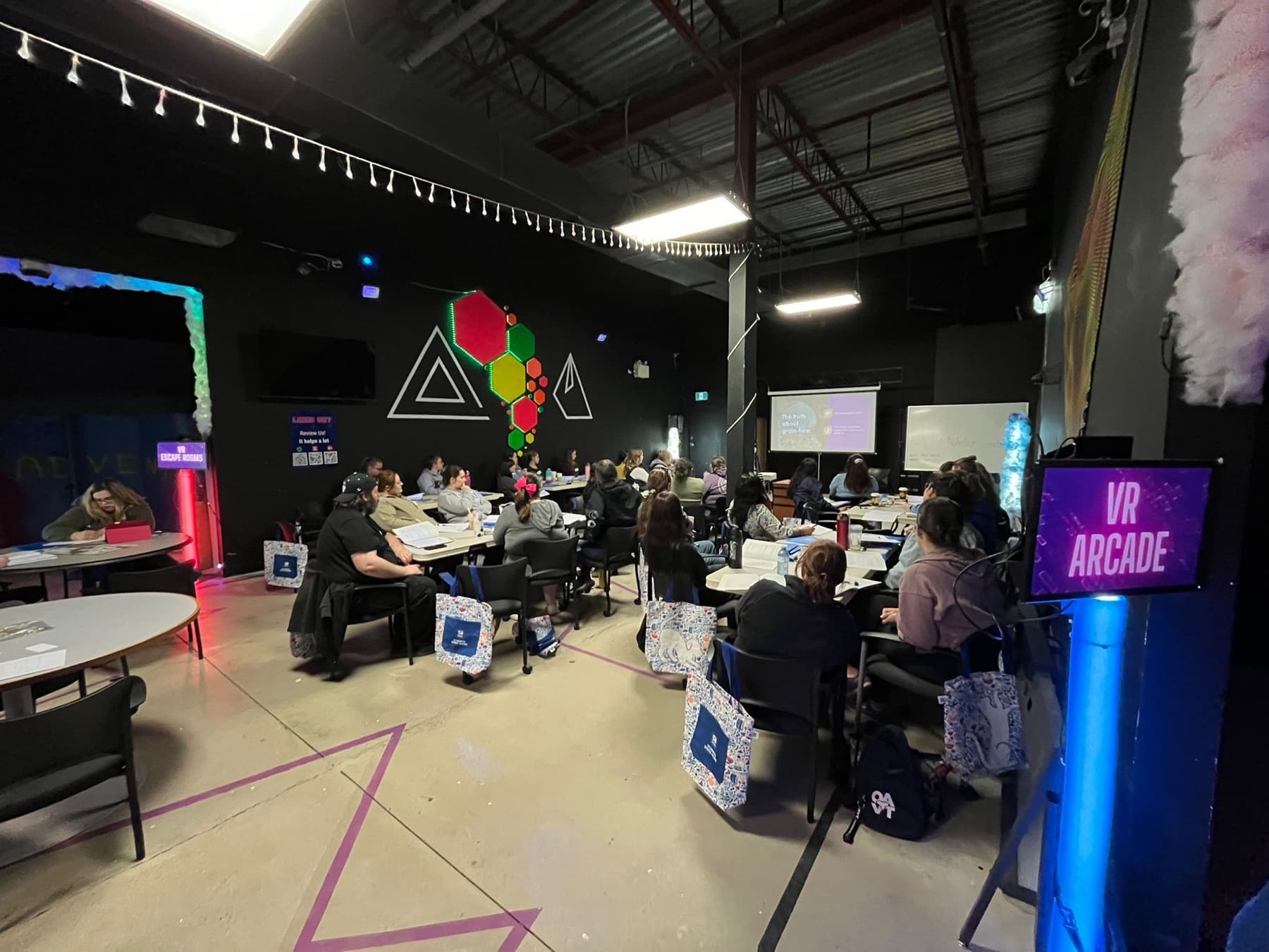A seated year-end meeting with a presentation screen inside the venue